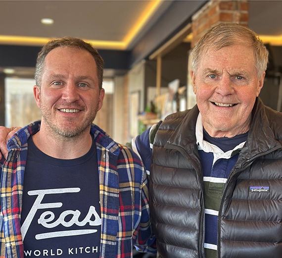 A group of people holding pumpkins and smiling